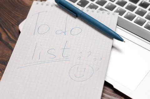 Image of a notebook with a pen lying on a laptop. Business planning concept.. Stock Photos