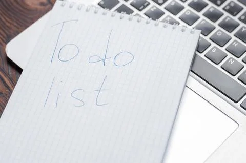 Image of a notebook with a pen lying on a laptop. Business planning concept.. Stock Photos