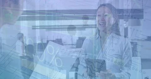 Image of numbers and loading over diverse female coworkers in office Stockfoto's
