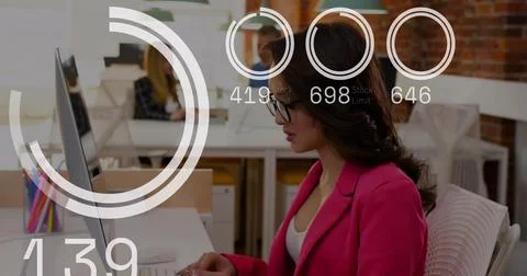 Image of numbers below circles over asian woman with eyeglasses using computer Stockfoto's