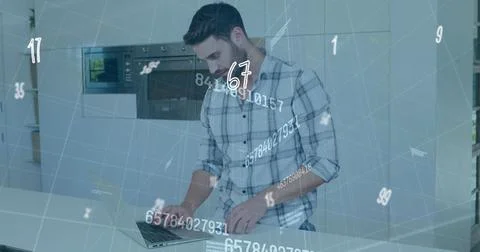 Image of numbers changing and data processing over man using laptop computer Foto stock