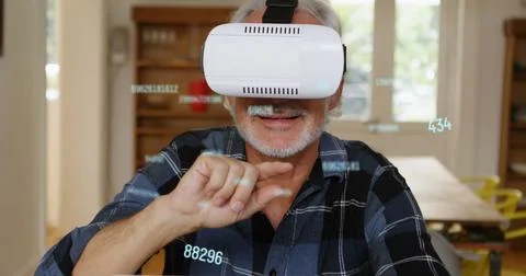 Image of numbers changing and processing over man wearing vr headset Fotos Stock