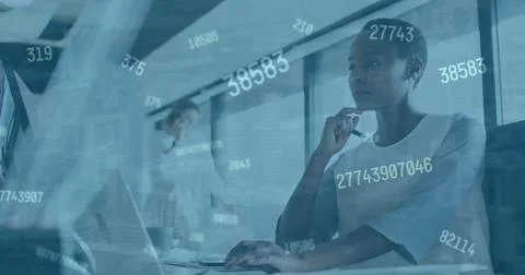 Image of numbers changing over afrcan american woman with computer in office Stock Photos