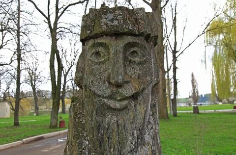 The image of an old man, forest goblin. Wooden sculptures of fabulous people Stock Photos