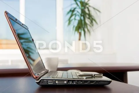 Image of open laptop on table in the office with pen on keyboard Stock Photos