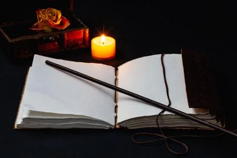 Image of open magic book on the table in the dark room. Stock Photos