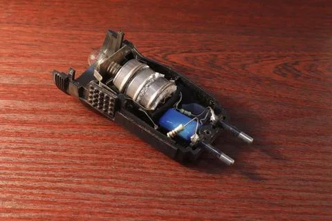 Image of an opened flashlight with old round batteries covered with oxides. Stock-Fotos