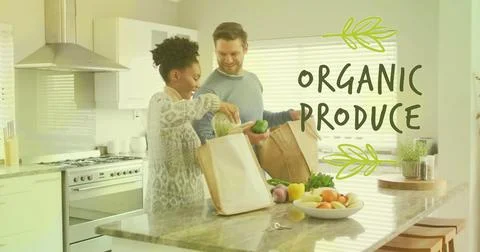 Image of organic produce text over diverse couple preparing healthy meal in Ilustração Stock