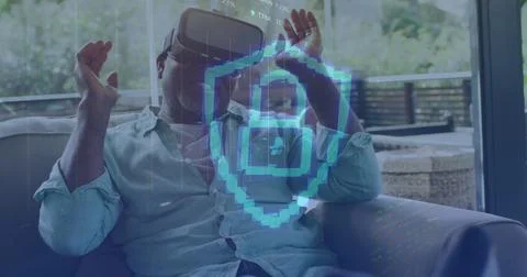 Image of padlock icon and data processing over african american man using v.. Stock Photos