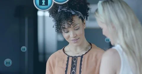 Image of padlock icons data processing over diverse businesswomen in office 写真素材
