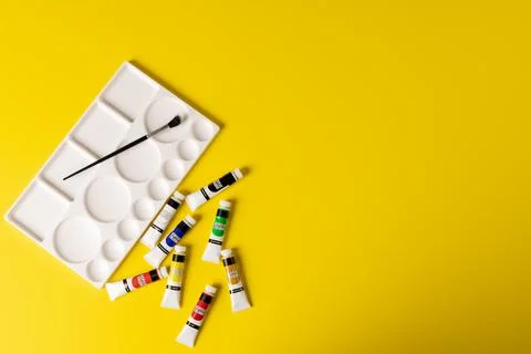 Image of painting tools on yellow surface with copy space Foto stock