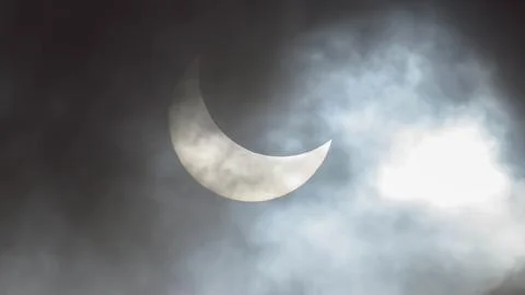 Image of a partial solar eclipse through veil clouds Stock Photos