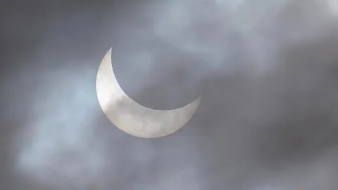 Image of a partial solar eclipse through veil clouds Fotos Stock