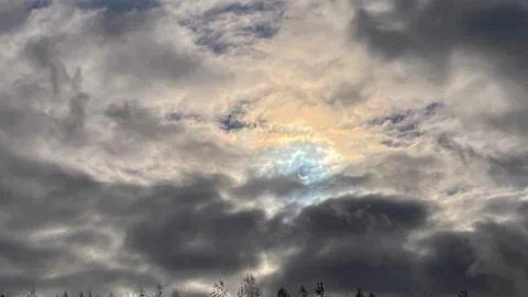 Image of a partial solar eclipse through veil clouds Fotos Stock