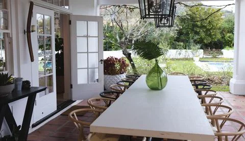 Image of patio with empty dining table and chairs Stock Photos