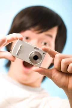 Image of photo camera in surprised guy hands after making a shot Stock Photos