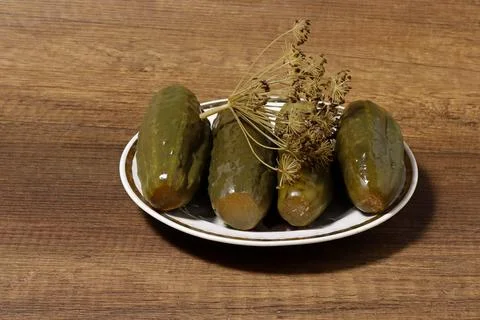 Image of pickled cucumbers on a plate on the table. Stock Photos