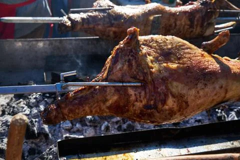 The image of a pig on a spit. Stock Photos