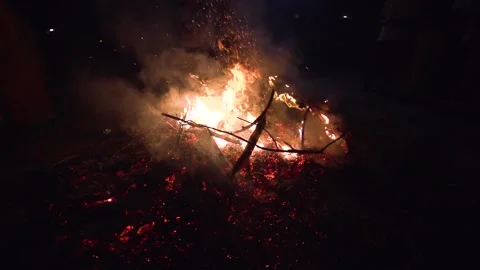 Image of a pile of trash burning in slow motion during the night. Stock Footage 151602704