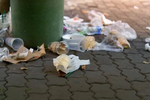 Image of plastic trash filled with trash that overflows outside. Stock Photos