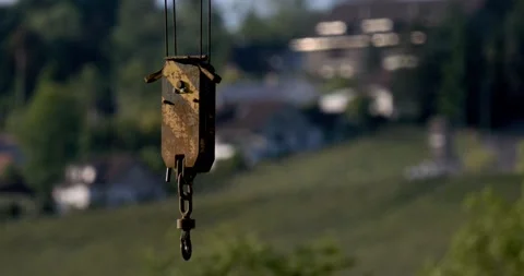 Image Portrays Corroded Crane Hook And Pulley Set Against Serene Natural Backdro Stock Footage 335579136