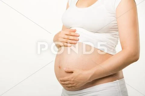 Image of pregnant woman touching her belly with hands Stock Photos