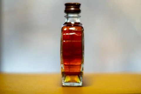 This image presents a tiny transparent container holding a reddish-brown subst Stock Photos