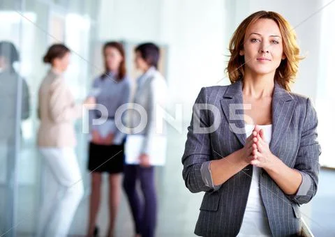 Image Of Pretty Business Leader Looking At Camera With Interacting Partners At B