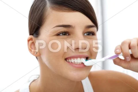 Image of pretty female brushing her teeth in the morning Stock Photos