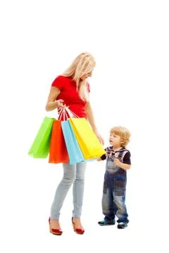 Image of pretty female holding bags full of presents or shoppings with her son n Stock Photos
