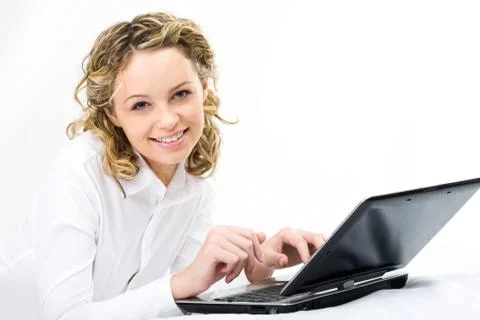 Image of pretty female looking at camera with laptop near by Stockfoto's
