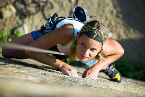 Image of pretty woman climbing on the rock Stock Photos