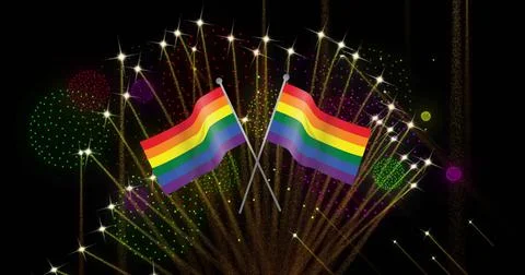 Image of pride rainbow flags and fireworks exploding on black background Stock Photos