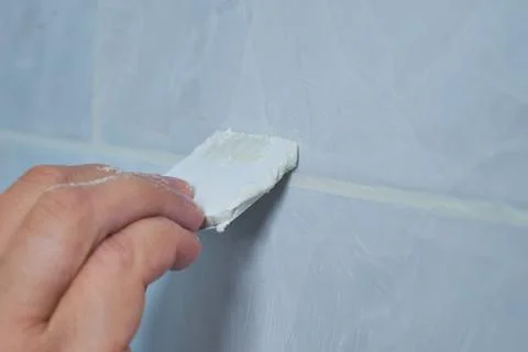 Image of the process of filling the seams of tiled mosaic. Stock Photos