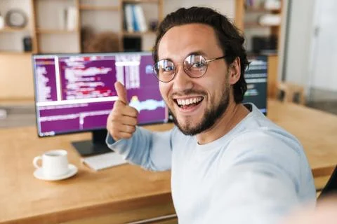 Image of programmer man showing thumb up while taking selfie photo Fotos de archivo