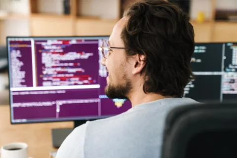 Image of programmer man wearing eyeglasses working with computers Stock Photos