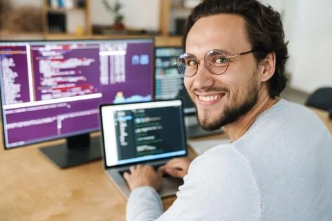 Image of programmer man wearing eyeglasses working with computers Stock Photos