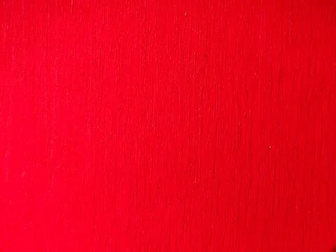 The image provided appears to show a red painted wood surface with a visibl.. Stock Photos