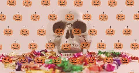 Image of pumpkins over skull and sweets on white background Ilustração Stock