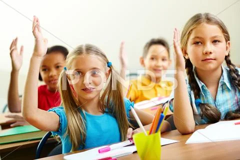 Image of pupils raising arms during the lesson Stock Photos