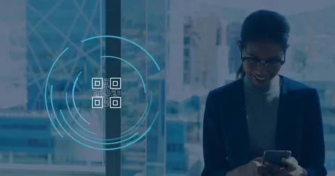 Image of qr code icon over biracial businesswoman using smartphone in office Stock Photos
