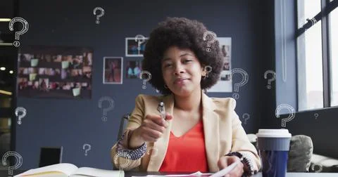 Image of question mark symbol over biracial businesswoman with afro hair writing Stock Photos