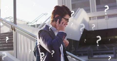 Image of question marks over asian businessman talking on cellphone while moving Stock Photos