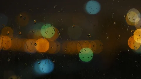 Image of raindrops on window at night in the city Stock Footage 99031293