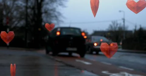 Image of red hearts falling over road traffic Stock Photos
