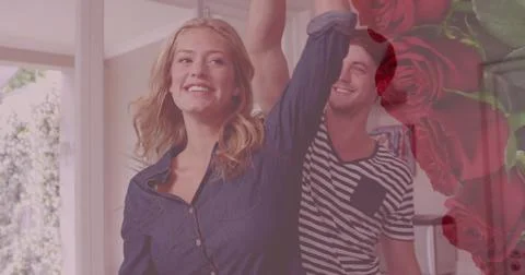 Image of red roses over smiling caucasian couple dancing Fotos Stock