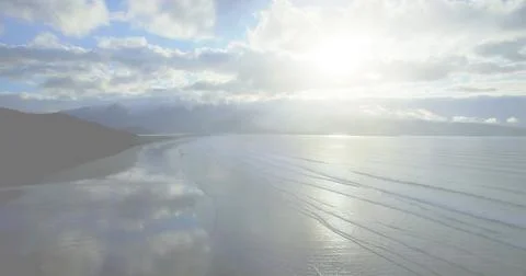 Image of red stripes and star, american flag elements over ocean and blue sky Foto stock