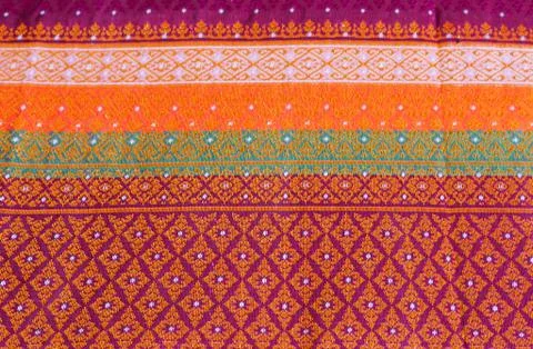 The image of the red Thai silk pattern that is woven in Thailand. Stock Photos