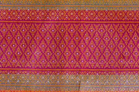 The image of the red Thai silk pattern that is woven in Thailand. Stock Photos