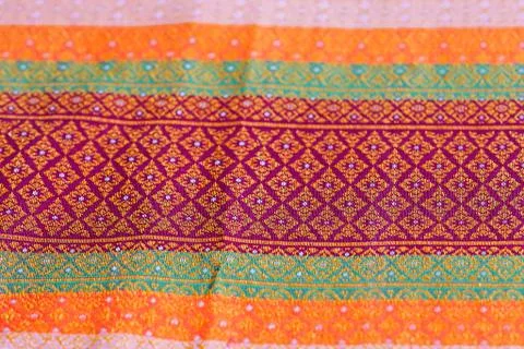 The image of the red Thai silk pattern that is woven in Thailand. Stock Photos